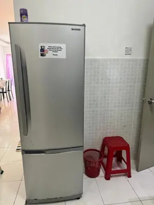 a refrigerator and a red stool in a kitchen at AYAAN LAVISH PRIMA APARTMENT FREE WiFi in Tanah Rata