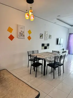 a dining room with a table and chairs at AYAAN LAVISH PRIMA APARTMENT FREE WiFi in Tanah Rata