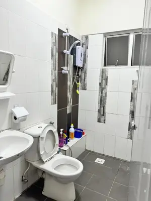 a bathroom with a toilet and a sink and a shower at AYAAN LAVISH PRIMA APARTMENT FREE WiFi in Tanah Rata