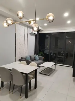 a living room with a table and a couch at Georgetown Ins Cozy Suites 2BR in George Town