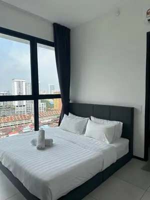 a bedroom with a large bed with a large window at Georgetown Ins Cozy Suites 2BR in George Town