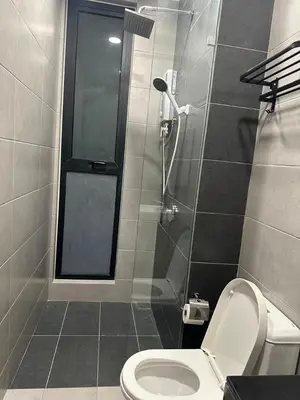 a bathroom with a toilet and a shower at Georgetown Ins Cozy Suites 2BR in George Town