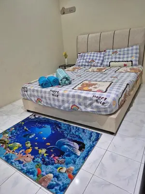 a bedroom with a bed with a rug on the floor at Vacation Ipoh Homestay for 12 Pax 4 Bedrooms for Delicious Food in Ipoh