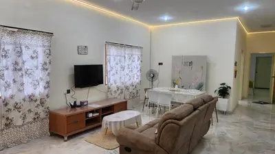 a living room with a couch and a table at Vacation Ipoh Homestay for 12 Pax 4 Bedrooms for Delicious Food in Ipoh