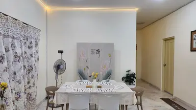 a dining room with a white table and chairs at Vacation Ipoh Homestay for 12 Pax 4 Bedrooms for Delicious Food in Ipoh