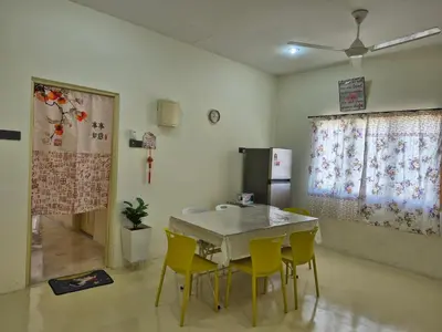 a dining room with a table and yellow chairs at Vacation Ipoh Homestay for 12 Pax 4 Bedrooms for Delicious Food in Ipoh