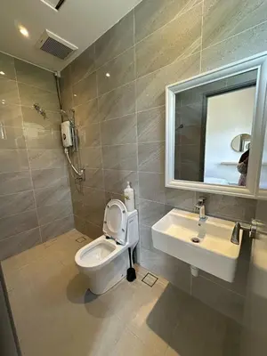 a bathroom with a toilet and a sink and a mirror at Adik Aisyah cameron semi-D goleden hill homestay in Brinchang