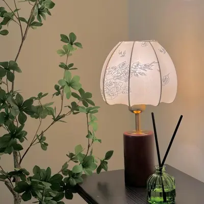 a lamp sitting on a table next to a plant at The Heritage 3BR Apartment at Town Centre in Ipoh