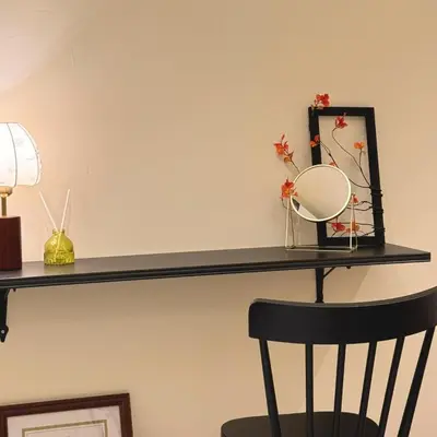 a shelf with a mirror and a chair on it at The Heritage 3BR Apartment at Town Centre in Ipoh