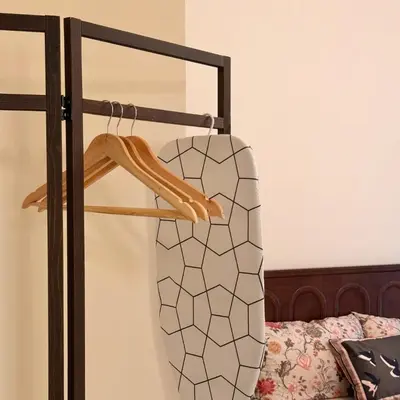 a bedroom with a bed and a suitcase on a rack at The Heritage 3BR Apartment at Town Centre in Ipoh