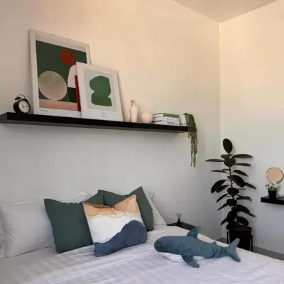 a bedroom with a bed with a stuffed animal on it at The Bay 6pax 2BR Apartment at Town Centre in Ipoh