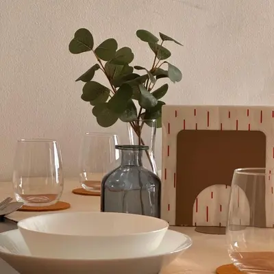 a table with glasses and a vase with a plant in it at The Bay 6pax 2BR Apartment at Town Centre in Ipoh