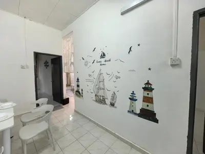 a room with a white wall with stickers on it at Padang Serai Harmoni Homestay in Padang Serai