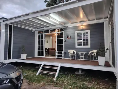 a pergola over a deck on a house at ZR Homestay in TanjongMalim