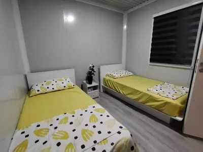 a bedroom with two beds and a window at ZR Homestay in TanjongMalim