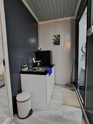 a small kitchen with a sink and a toilet at ZR Homestay in TanjongMalim