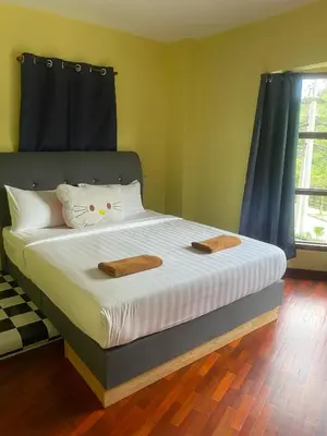 a bedroom with a bed with two towels on it at Highlanders Apartment in Tanah Rata