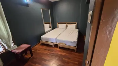 a small bedroom with a bed and a mirror at Highlanders Apartment in Tanah Rata