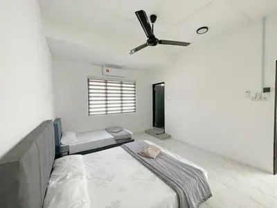 a bedroom with a bed and a ceiling fan at Muji Zen Minimalist Guest House in Teluk Intan
