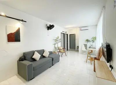 a living room with a couch and a table at Muji Zen Minimalist Guest House in Teluk Intan
