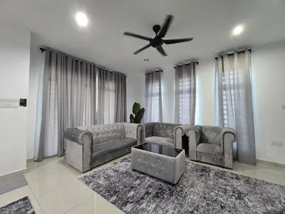 a living room with a couch and a ceiling fan at HOMESTAY KLeMERU E POH in Chemor