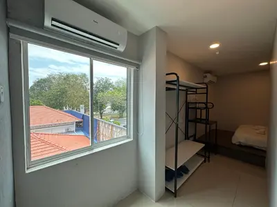 a room with a window and a bedroom with a bed at Georgetown Hotel in George Town