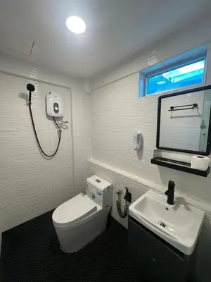 a bathroom with a white toilet and a sink at Georgetown Hotel in George Town