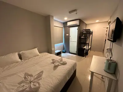 a bedroom with a white bed with bows on it at Georgetown Hotel in George Town