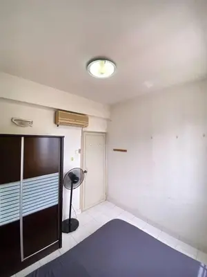 a room with a large blue rug in a room at sunny point complex in Gelugor