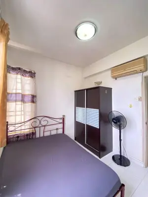 a bedroom with a blue bed in a room at sunny point complex in Gelugor