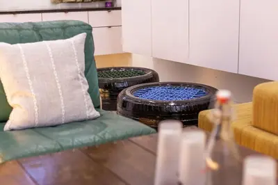 a living room with a green chair and two baskets at Unique Design House, 2BR House - Near Ipoh Local Foodies in Ipoh