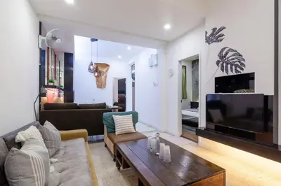 a living room with a couch a table and a tv at Unique Design House, 2BR House - Near Ipoh Local Foodies in Ipoh