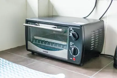 a black toaster oven sitting on the floor at Unique Design House, 2BR House - Near Ipoh Local Foodies in Ipoh