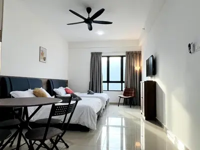 a hotel room with a bed and a table and chairs at Studio 2bed4pax KekLokSi View in Ayer Itam