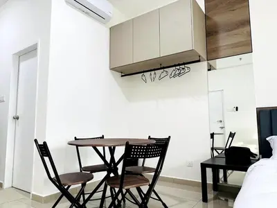 a kitchen with a table and chairs in a room at Studio 2bed4pax KekLokSi View in Ayer Itam