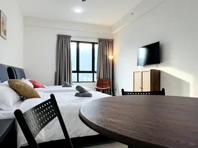 a room with two beds and a table and a television at Studio 2bed4pax KekLokSi View in Ayer Itam