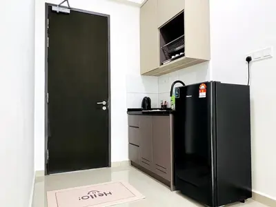 a kitchen with a black refrigerator in a room at Studio 2bed4pax KekLokSi View in Ayer Itam