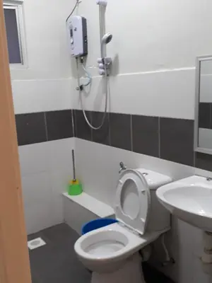 a bathroom with a toilet and a sink at Camlodge apartments in Tanah Rata
