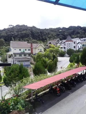 a group of motorcycles parked at a gas station at Camlodge apartments in Tanah Rata