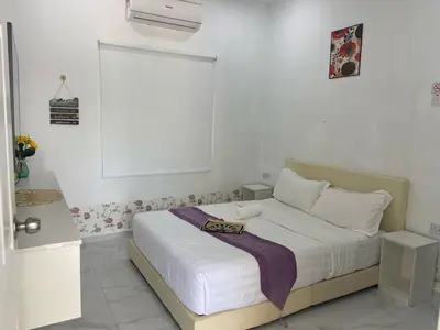 a bedroom with a bed with white sheets and a window at Sammy Hoomestay Ipoh in Ipoh