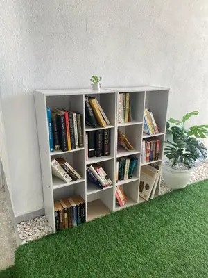 a white book shelf with books on it at Sammy Hoomestay Ipoh in Ipoh