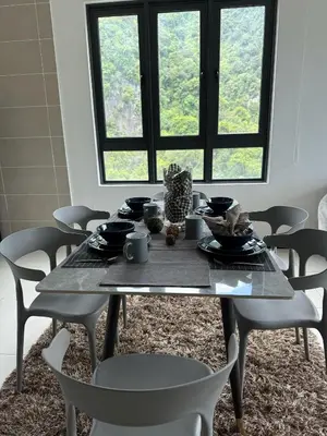 a dining room table with chairs and a tableasteryasteryasteryasteryasteryasteryastery at Sunway Onsen Suites in Tambun
