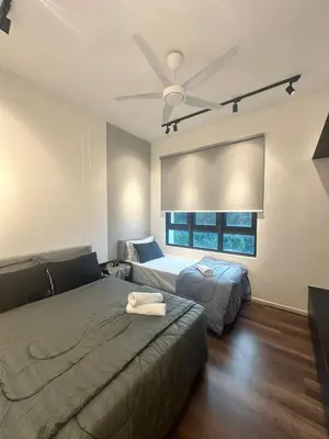 a bedroom with two beds and a ceiling fan at Sunway Onsen Suites in Tambun