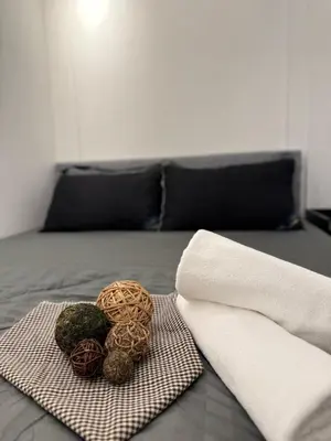 a bed with a pile of balls on a towel at Sunway Onsen Suites in Tambun