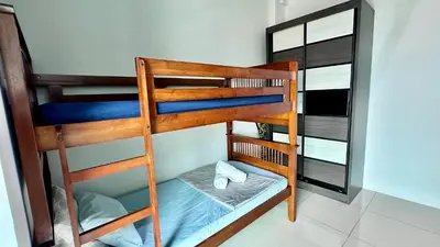 a bunk bed room with two bunk beds in a room at 2BR Lively City View Family Suite#Airport in Bayan Lepas