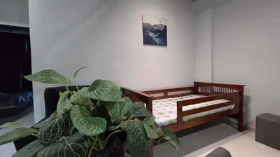 a room with a bed and a potted plant at 2BR Lively City View Family Suite#Airport in Bayan Lepas