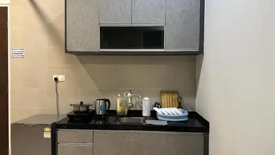 a kitchen counter with a sink and a microwave at 2BR Lively City View Family Suite#Airport in Bayan Lepas