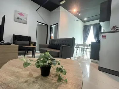 a living room with a table with a potted plant at 2BR Airport Panoramic View Family Suite in Bayan Lepas