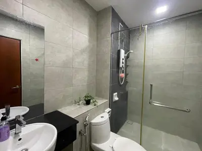 a bathroom with a shower and a toilet and a sink at 2BR Airport Panoramic View Family Suite in Bayan Lepas