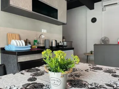 a kitchen with a table with a potted plant on it at 2BR Airport Panoramic View Family Suite in Bayan Lepas